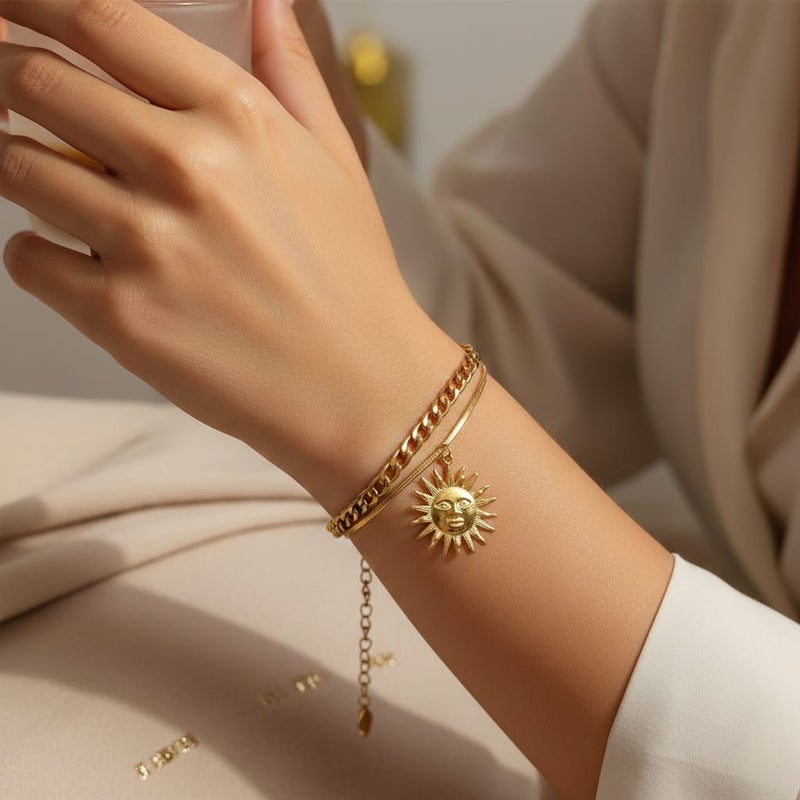 An elegant gold bracelet made of rust-resistant stainless steel, with a double design combining a wide chain and a smooth chain with an attractive sun pendant, with an adjustable clasp to suit you. - Image 1
